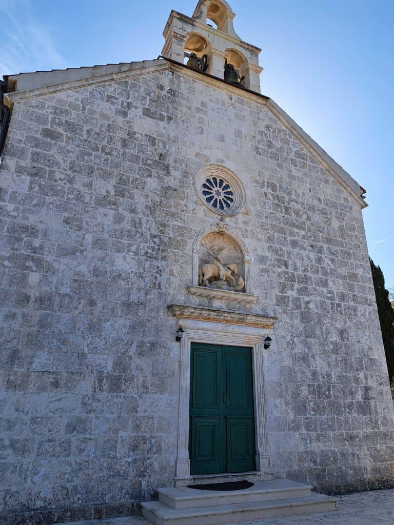 Stone facade of the parish church in Brusje