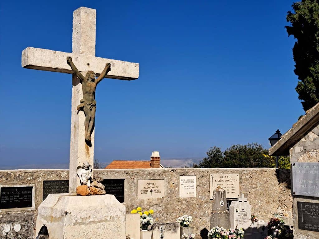 Stone crucifix in the village cemetery in Brusje