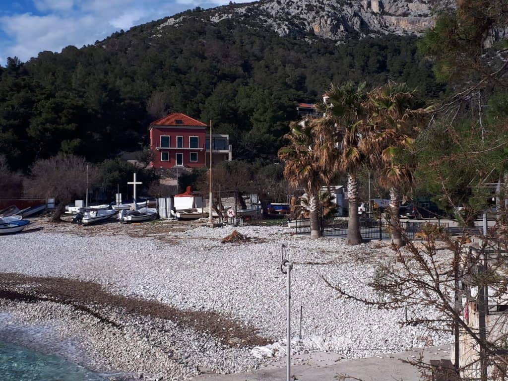 Boats pulled up on the pebble beach at Milna
