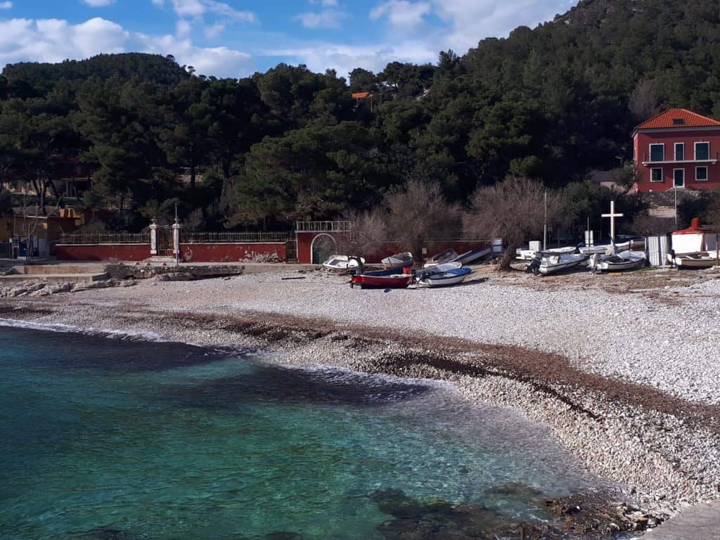 Pebble beach and clear shallow water at Milna