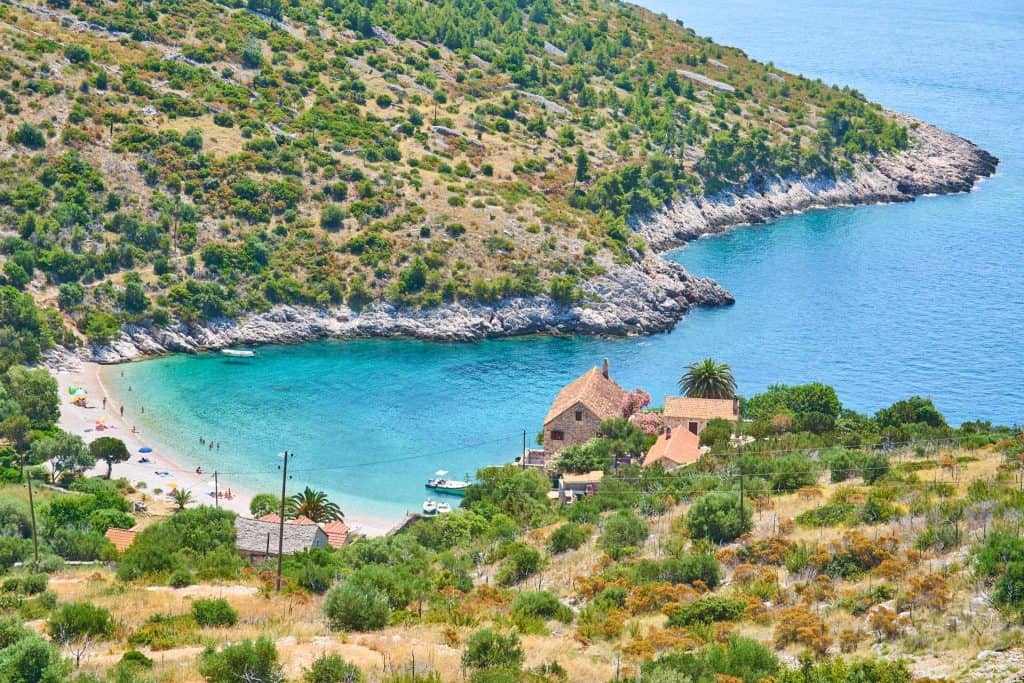 Dubovica beach with the old stone house on the shore