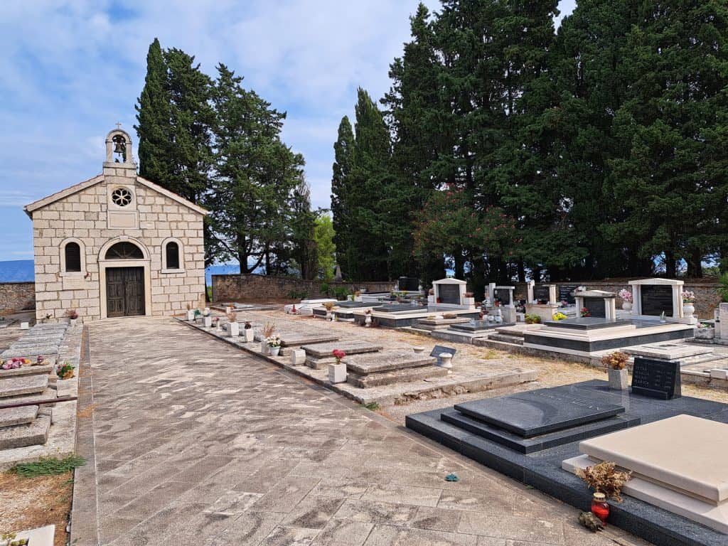 Stone chapel and the village cemetery in Pitve
