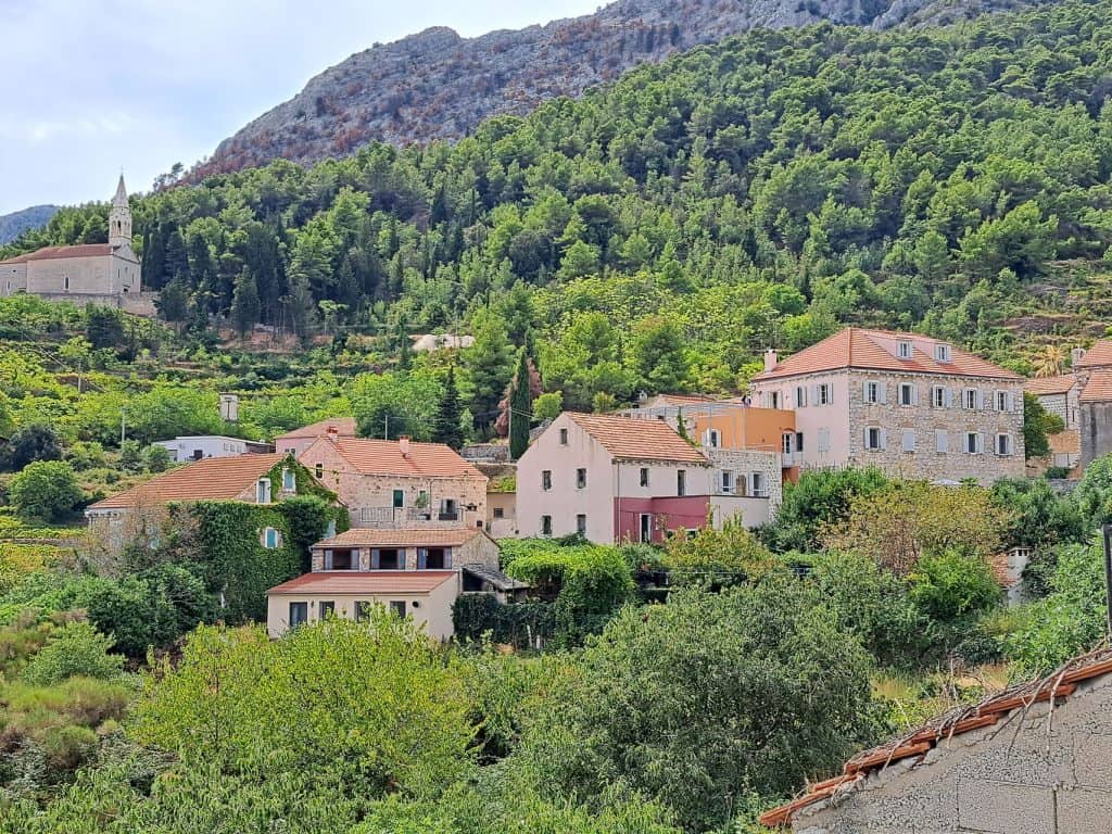 Houses of Pitve on the green hillside below the ridge