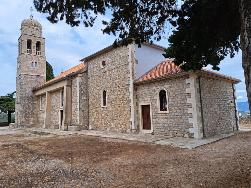 Stone parish church and bell tower in Vrisnik