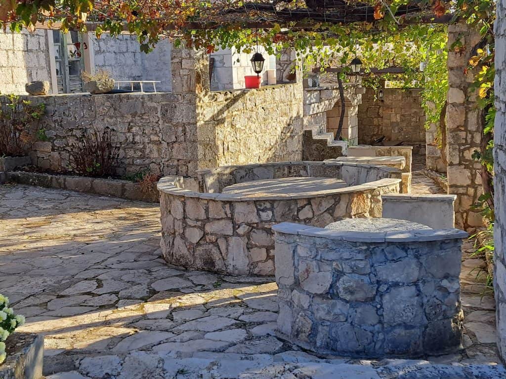 Old stone cistern in a courtyard in Selca near Bogomolje
