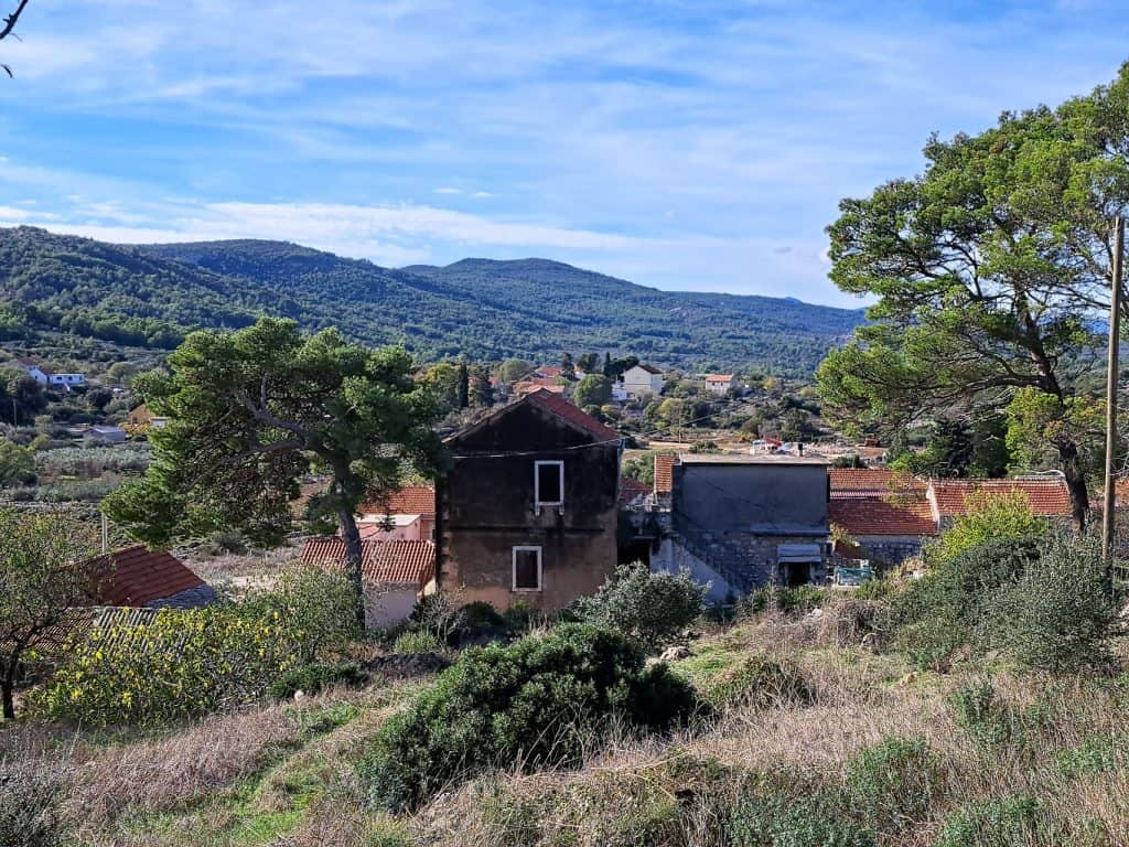 Stone houses of Zastražišće on the green slope