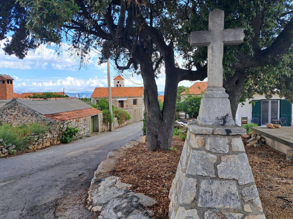 Stone cross beside the road at the entrance to Poljica