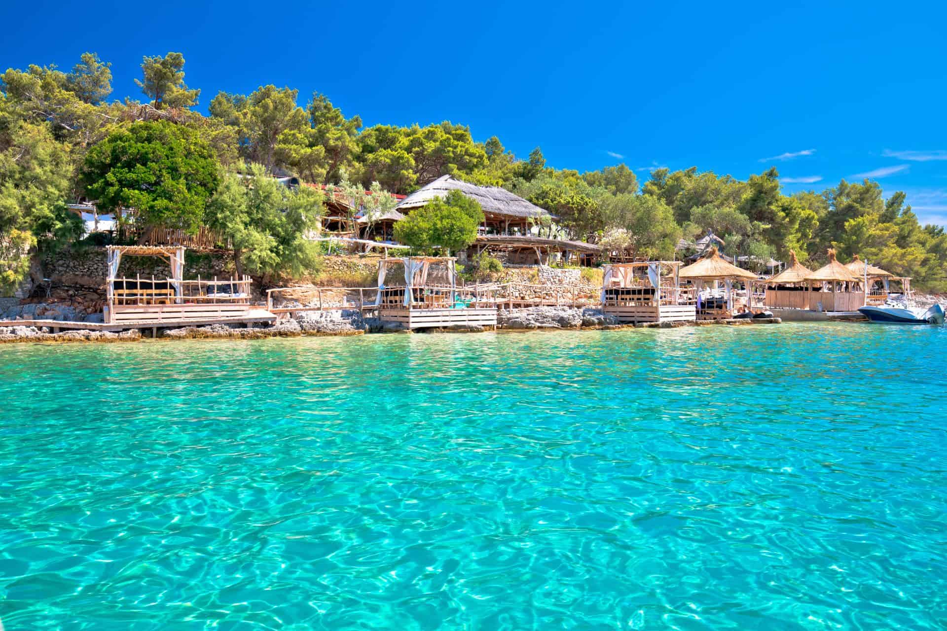 Palmizana bay in the Pakleni Islands, with moored boats and pine trees running down to the sea