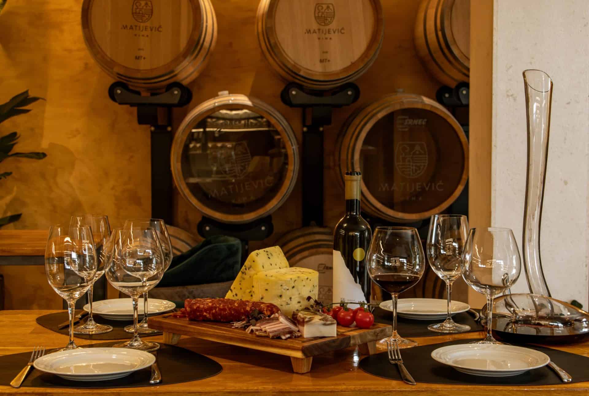 A tasting table set with wine and a platter at Matijević winery
