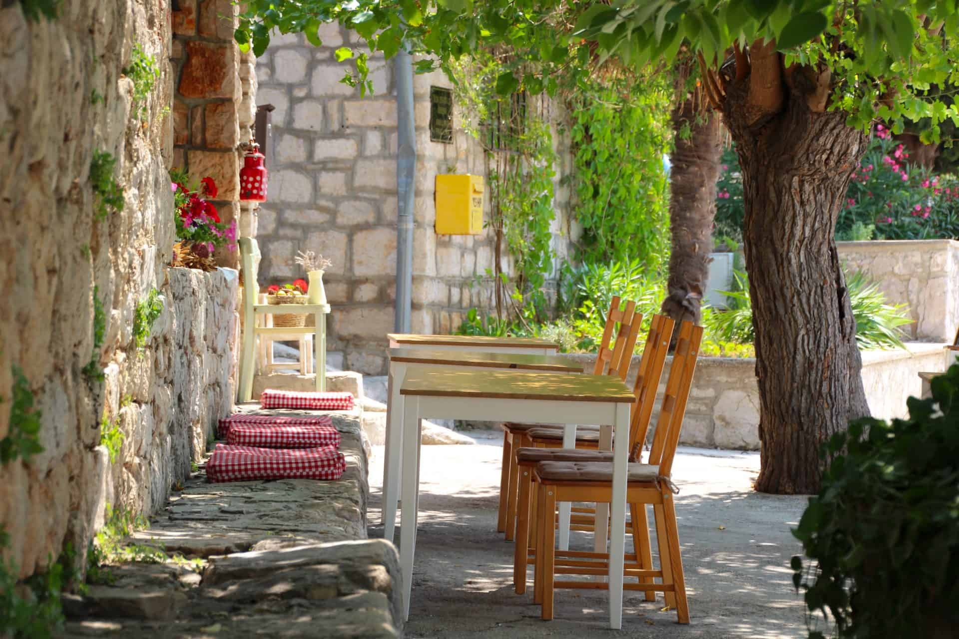 A stone konoba terrace set for lunch
