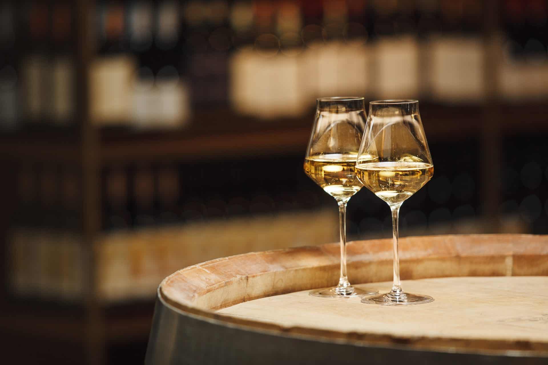 White wine glasses on barrel