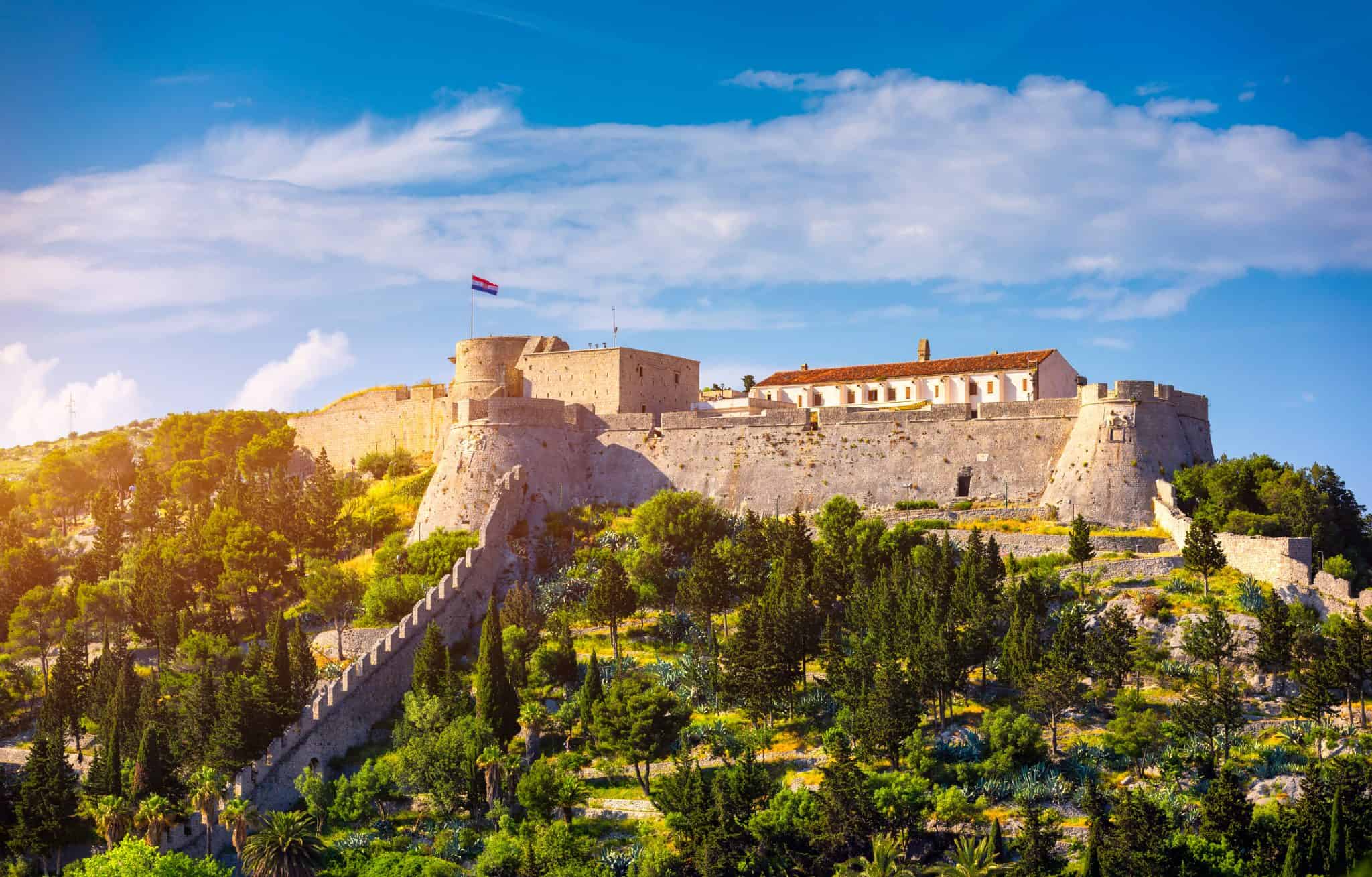 The whole Spanish fortress above Hvar town on a sunny day, with the Pakleni islands behind