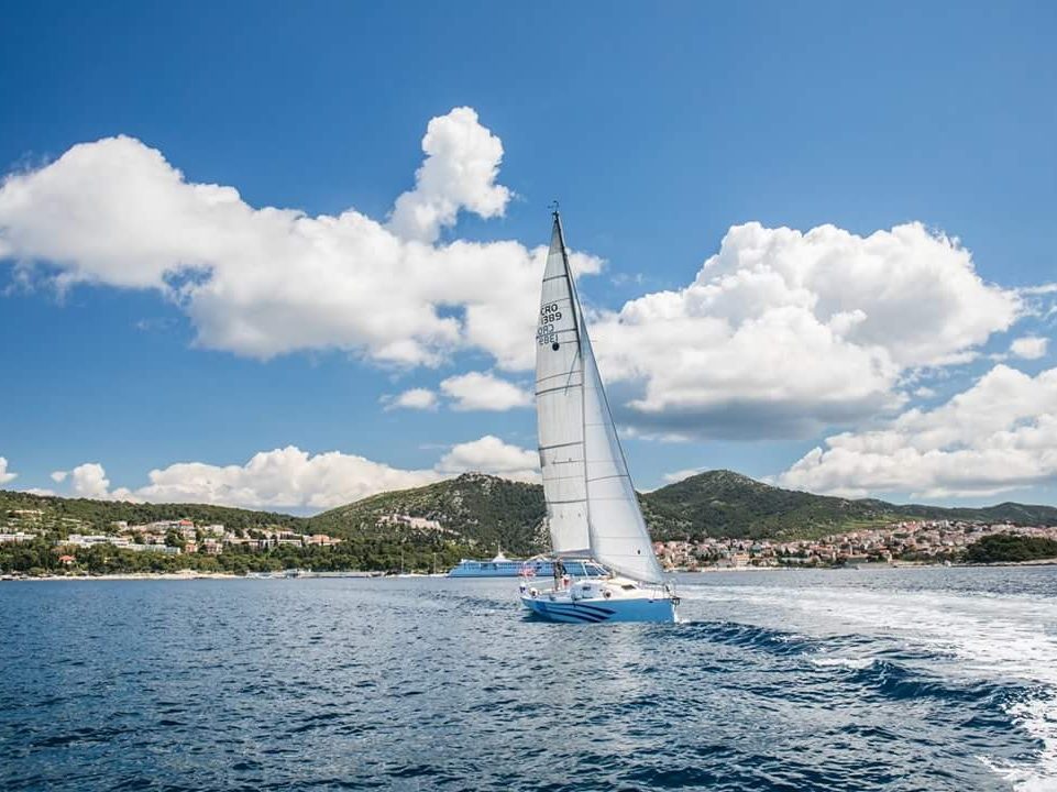 Sailing tour from Hvar town, yacht under full sail off the island of Hvar, Croatia